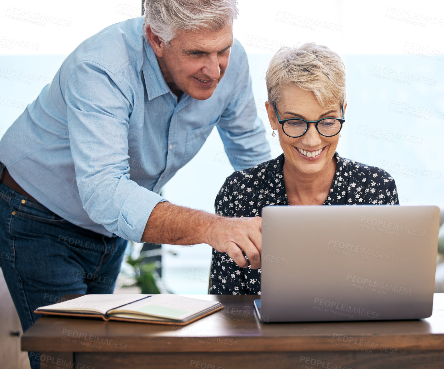 Buy stock photo Mature couple, laptop and smiling with choices for retirement, vacation and holiday at home. Woman on computer, man and excited for destinations for trip, browsing and budgeting in living room