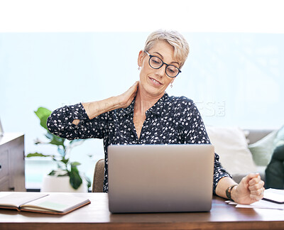 Buy stock photo Home, laptop and woman with neck pain at desk for remote work, burnout and health problem. Frustrated, table and technology with mature freelancer for muscle injury, accident and fatigue of body