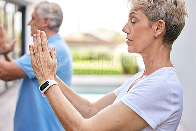 Buy stock photo Shot of a mature couple meditating together outdoors