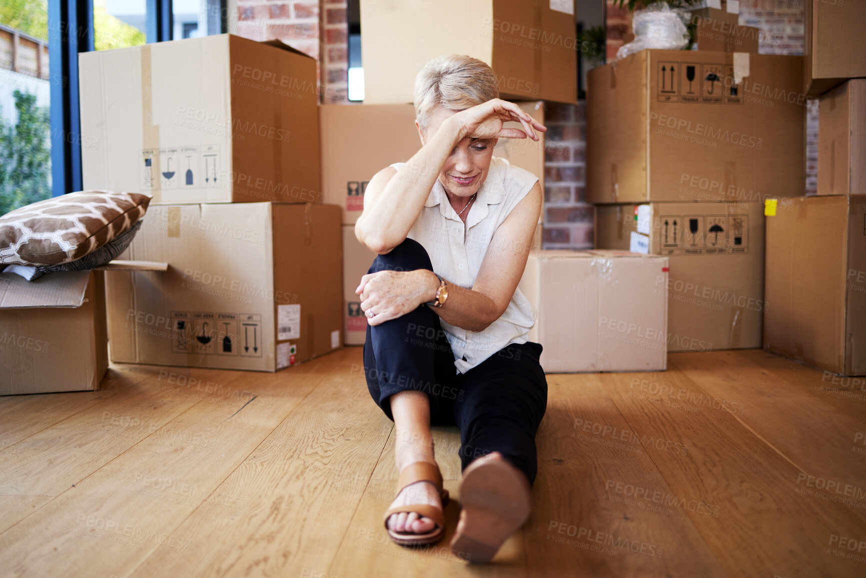 Buy stock photo Mature woman, tired and boxes in new home, burnout and exhausted on floor, moving and sad for leaving. Rent, apartment and person in property, rest and thinking of mortgage of house, stress and wood