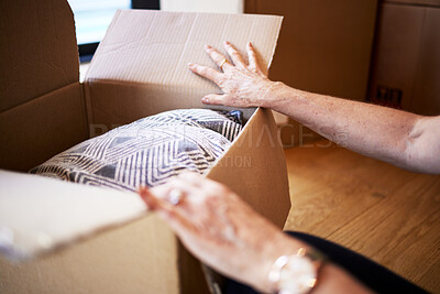Buy stock photo Shot of a mature woman  unpacking boxes on moving day