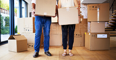 Buy stock photo Shot of an unrecognisable mature couple carrying boxes on moving day