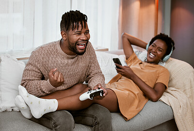 Buy stock photo Gaming, laughing and winning with black couple on sofa in living room of home together for weekend bonding. Celebration, next level and success with happy people playing video games in apartment