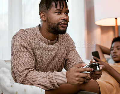 Buy stock photo Black couple, sofa and serious with entertainment for bonding, playing and streaming at home. Man, woman and together and relax on couch and phone for music, video games and fun in lounge in Nigeria