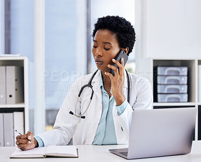 Buy stock photo Cropped shot of an attractive young female doctor taking notes while making a phonecall in her office