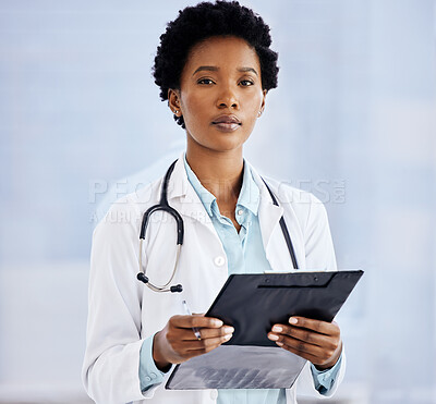 Buy stock photo Cropped portrait of an attractive young female doctor using her tablet while standing in the office