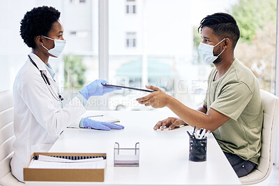 Buy stock photo Cropped shot of an attractive young female doctor handing a clipboard to a male patient during a consult