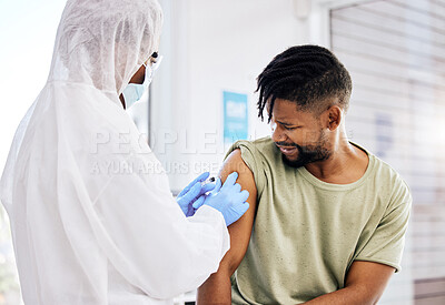Buy stock photo Cropped shot of an unrecognizable doctor administering the covid 19 vaccine to a handsome young male patient