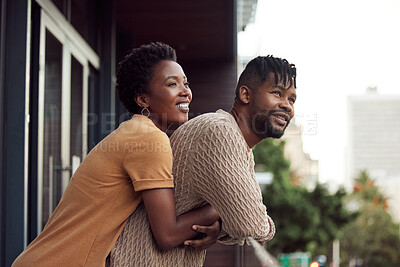 Buy stock photo Shot of an affectionate your couple bonding on a balcony outdoors