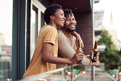 Buy stock photo Shot of an affectionate your couple drinking beer while bonding on a balcony outdoors