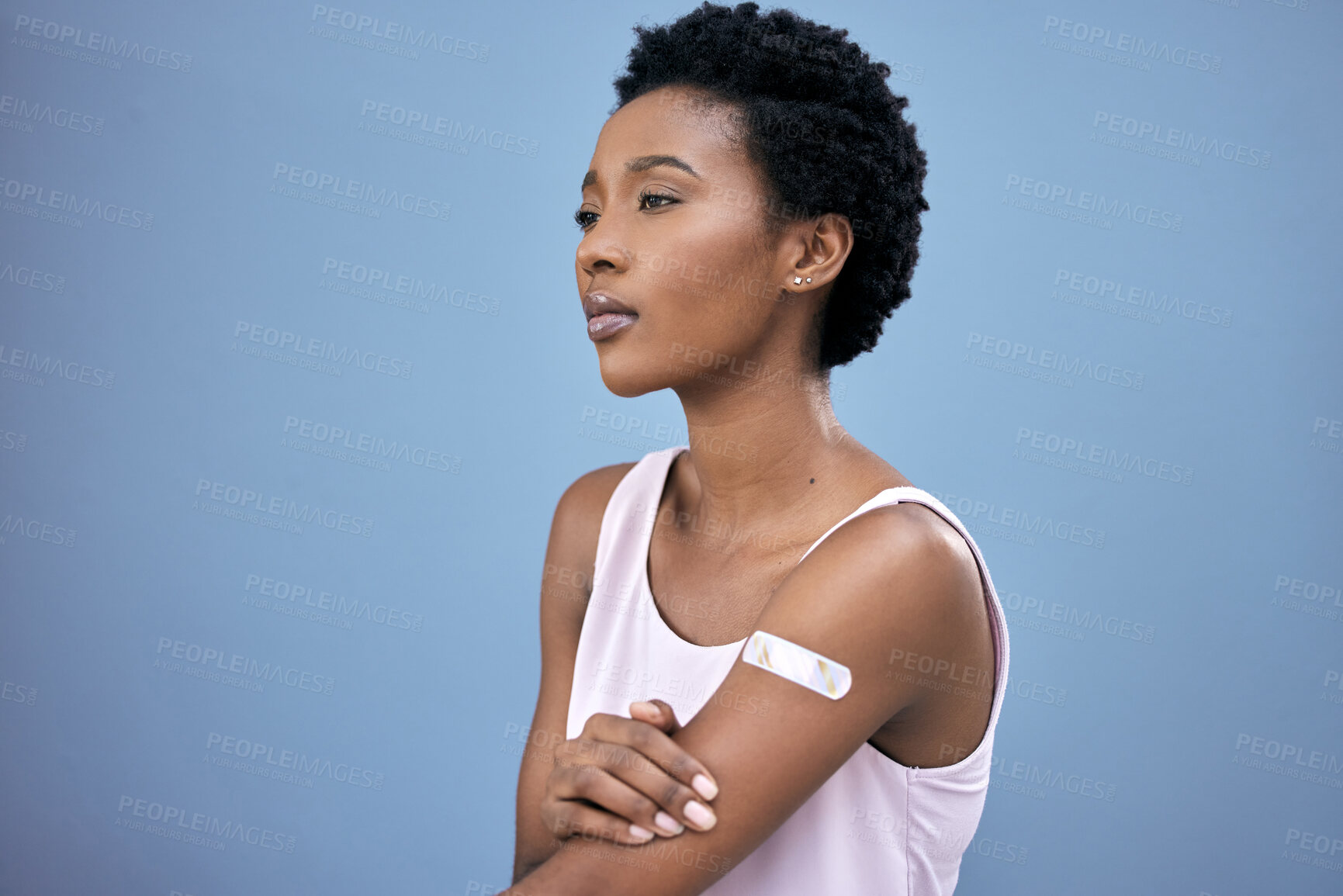 Buy stock photo Arm plaster, thinking and a black woman after the vaccine isolated on a blue background in a studio. Health, idea and an African person with a cover after vaccination for safety from covid virus