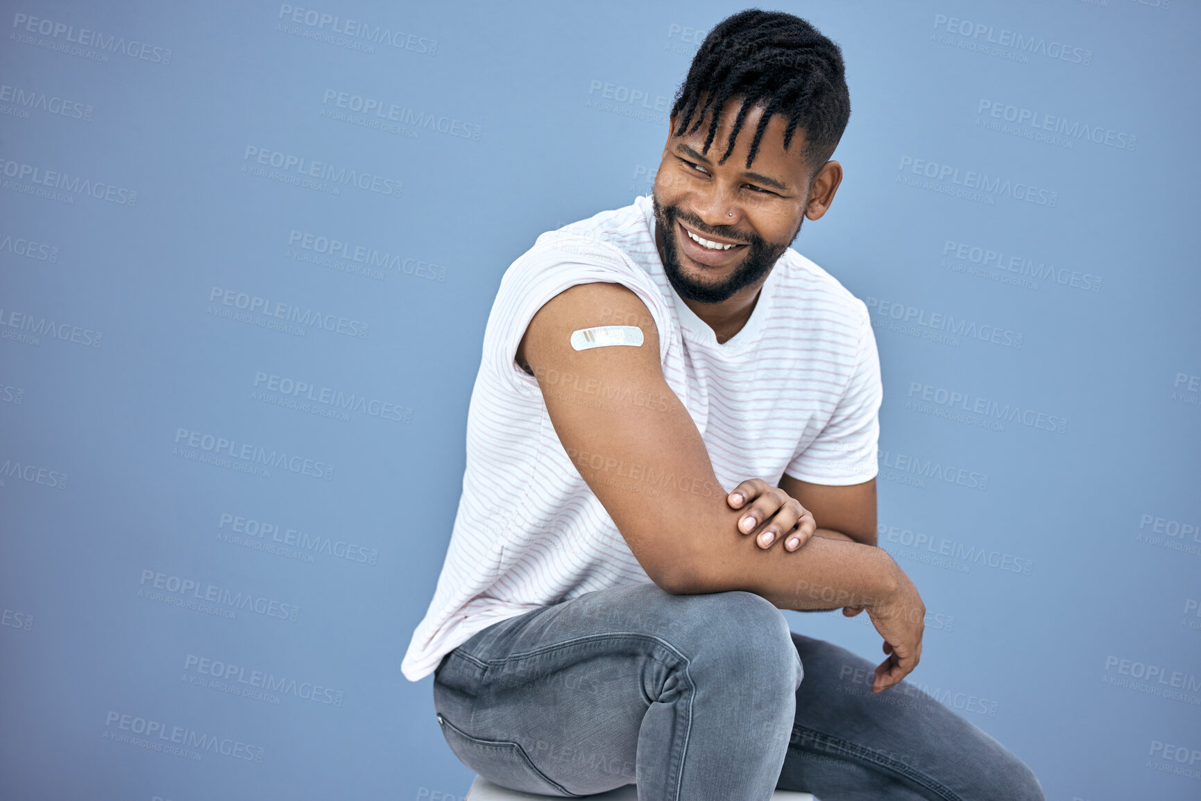 Buy stock photo Vaccine, healthcare and black man with plaster in studio for flu, disease or illness prevention. Smile, wellness and African male person with plaster for medical immunization by gray background.