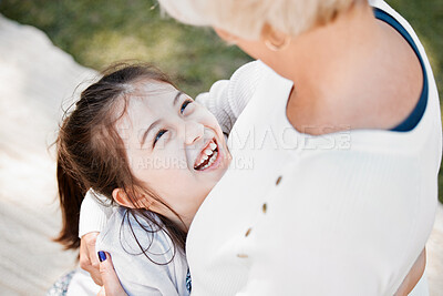 Buy stock photo High angle shot of a little girl hugging her grandmother outdoors