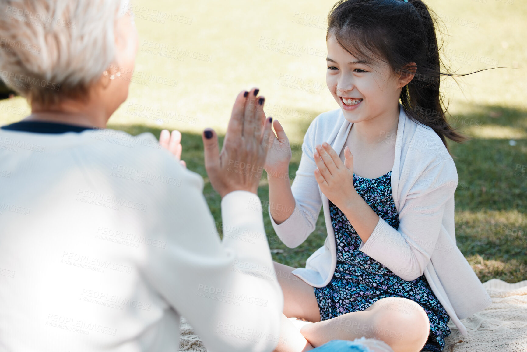 Buy stock photo Grandma, girl and smile in park for playing game for bonding, support and care on child development. People, trust and happy in outdoor for memories, fun and growth as family on holiday in London