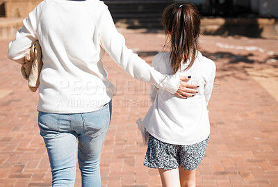 Buy stock photo Rearview shot of a little girl walking with her grandmother in a outdoors