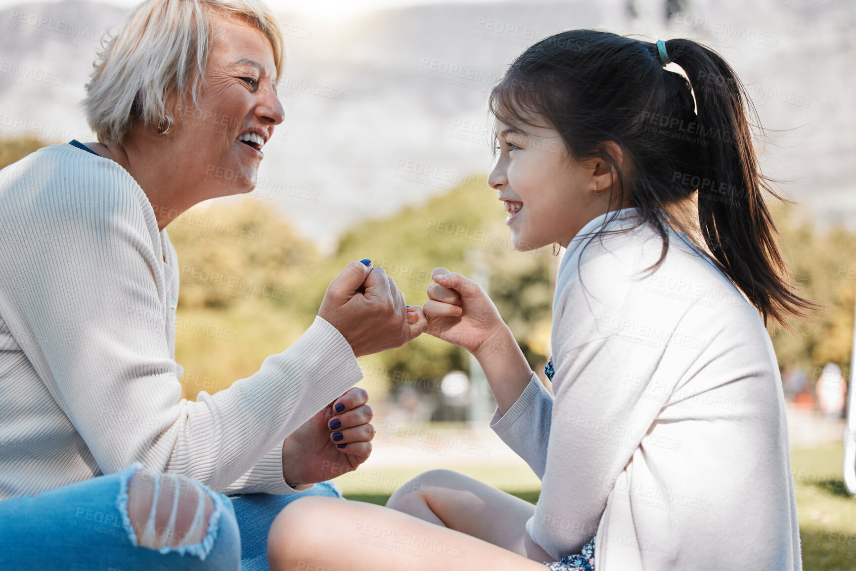 Buy stock photo Grandma, girl and happy with pinky promise in park for bonding, support and care on child development. People, adoption and smile in playing for memories, fun and growth as family in New York