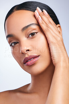 Buy stock photo Shot of a beautiful young woman posing against a grey background