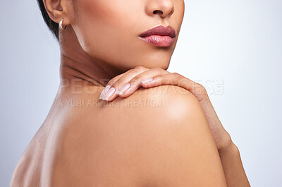 Buy stock photo Cropped shot of an unrecognizable woman looking over her shoulder against a grey background