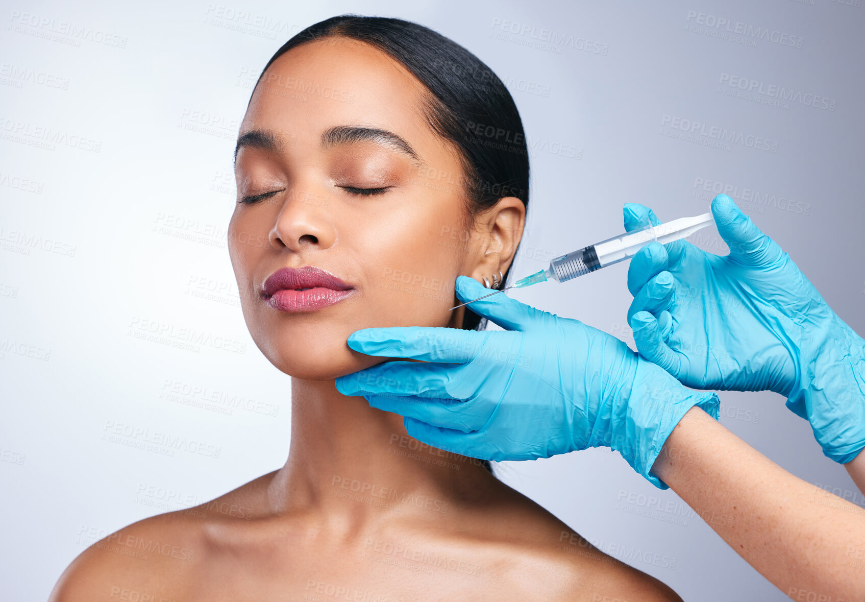 Buy stock photo Woman, studio and gloves with needle, surgery or cosmetics for skin, facial or collagen by white background. Girl cosmetic surgeon and filler on face, syringe or hands for beauty, skincare or change
