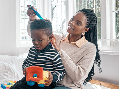 Buy stock photo Black family, mother and comb hair of kid in home bedroom for grooming, care or bonding. African mom, smile and combing child or boy for afro hairstyle, haircare and playing to enjoy time together.