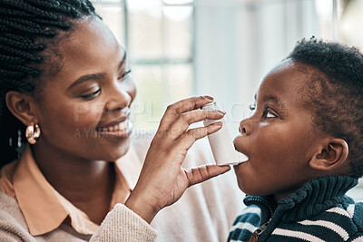 Buy stock photo Shot of a woman helping her son with his inhaler