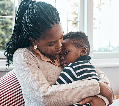 Buy stock photo Shot of a woman comforting her young son at home