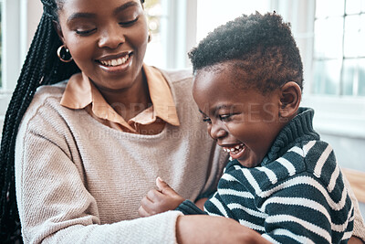 Buy stock photo Shot of a little boy and his mother playing at home