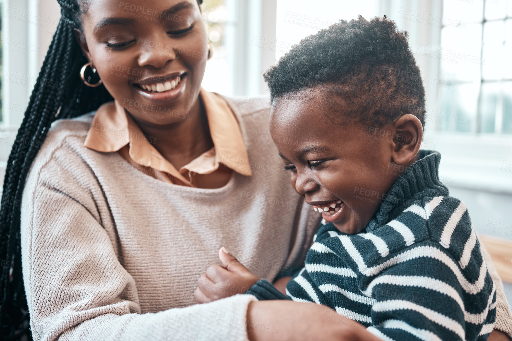Buy stock photo Love, smile or tickle with mother and son in living room of home together for bonding, fun or laughing. Black family, happy or playing with woman parent and boy child in apartment for comedy or humor