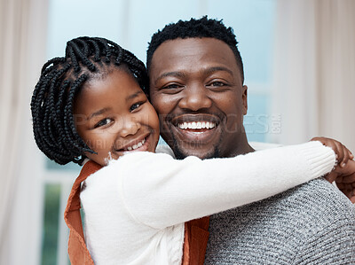 Buy stock photo Shot of a young father hugging his daughter while bonding at home