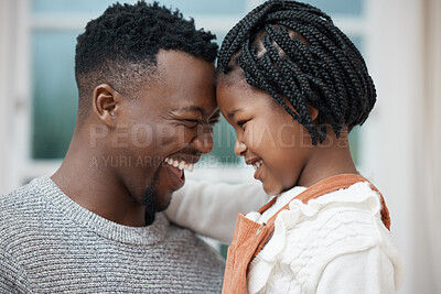 Buy stock photo Shot of a young father bonding with his daughter at home