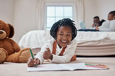 Buy stock photo Shot of an adorable little girl lying on the floor in the bedroom and drawing