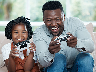 Buy stock photo Shot of a father and his daughter playing video games together at home