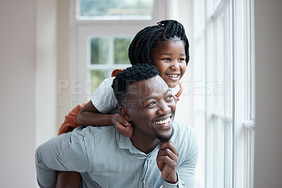 Buy stock photo Shot of a father giving his daughter a piggyback ride at home