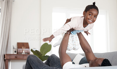 Buy stock photo Cropped portrait of an adorable little girl playing with her dad on the sofa at home