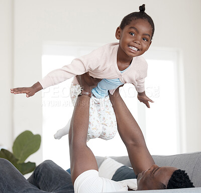 Buy stock photo Cropped portrait of an adorable little girl playing with her dad on the sofa at home