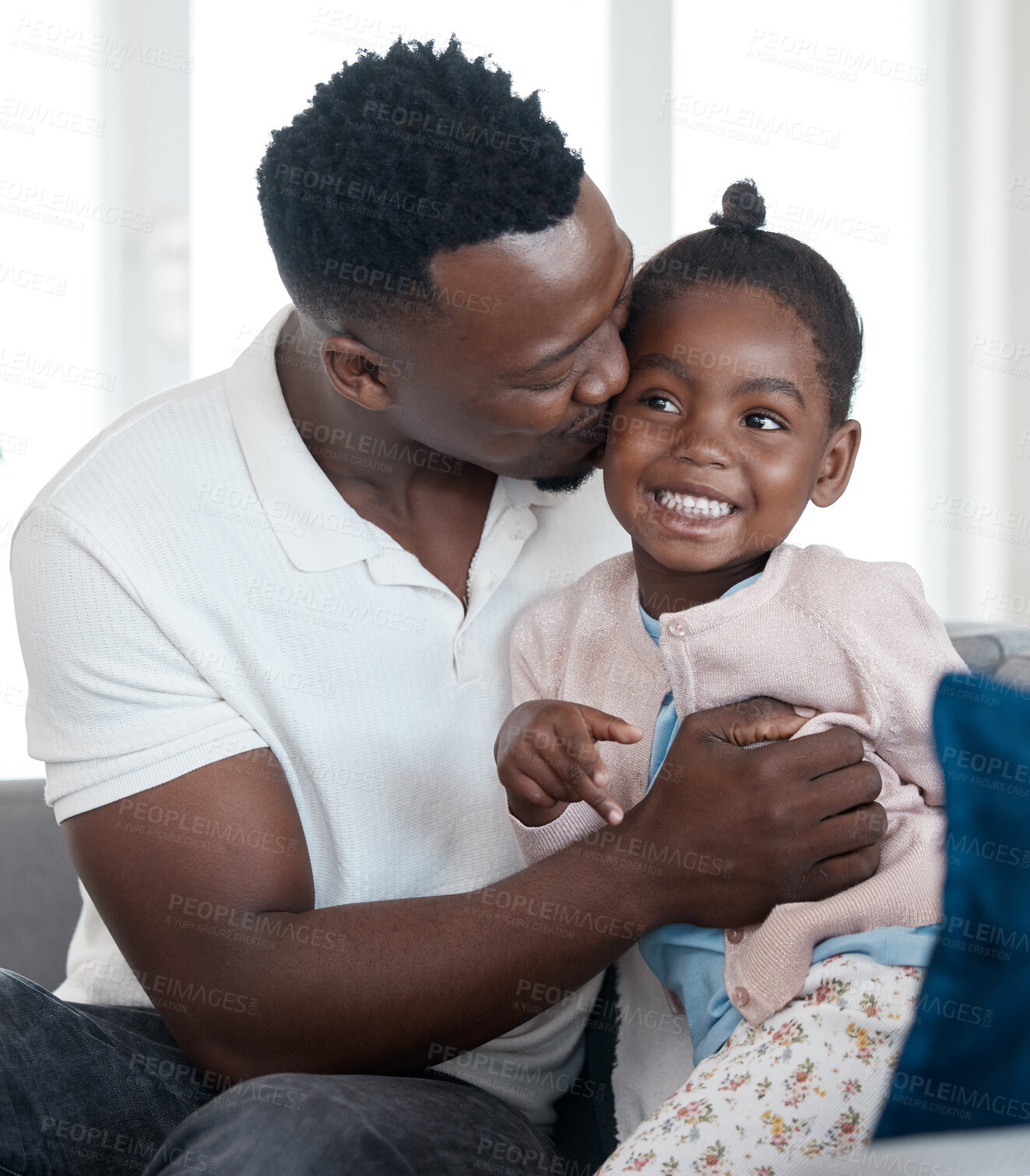 Buy stock photo Happy, kiss and black man with child on sofa for bonding, relaxing and hugging in living room. Smile, love and African father embracing girl kid with care resting in lounge for family time at home.