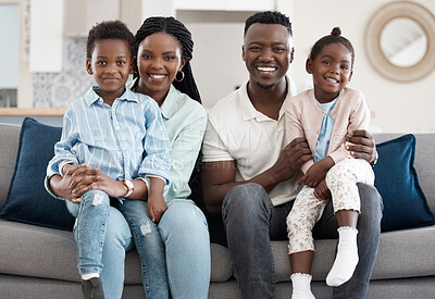 Buy stock photo Cropped portrait of an affectionate young family of four relaxing in the living room at home