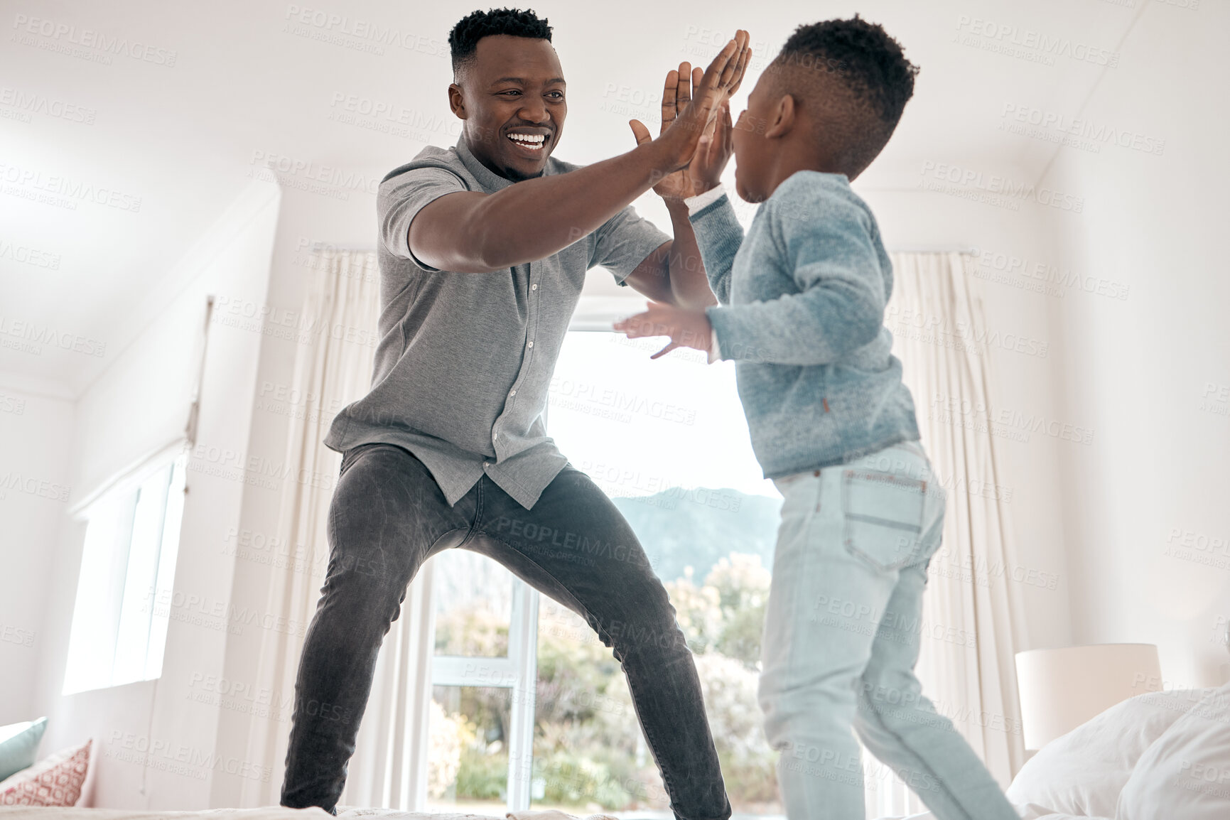 Buy stock photo Happy, father and boy with high five on bed for playing, bonding and fun time in morning at home. Excited, family and child with smile and hand gesture for affection, love and growth in bedroom