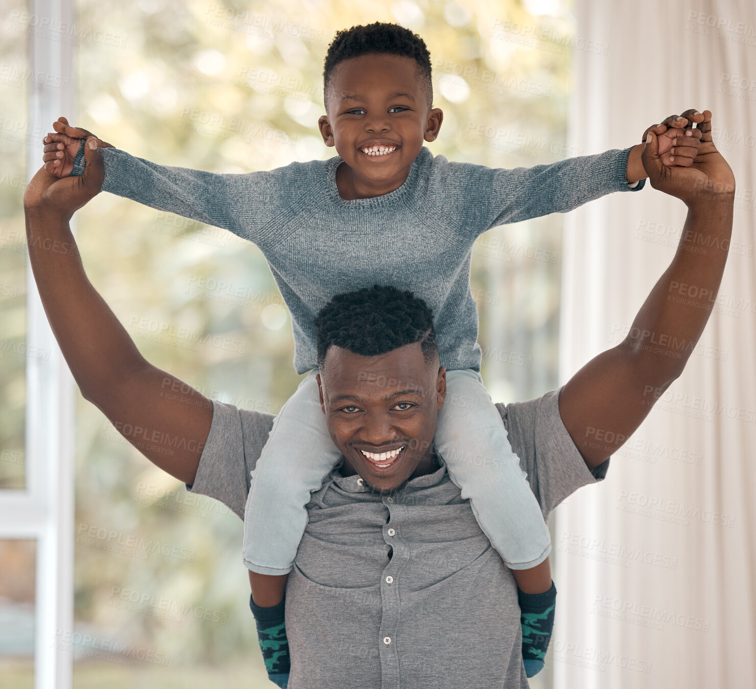 Buy stock photo Cropped portrait of a handsome young man standing in the bedroom at home with his son on his shoulders