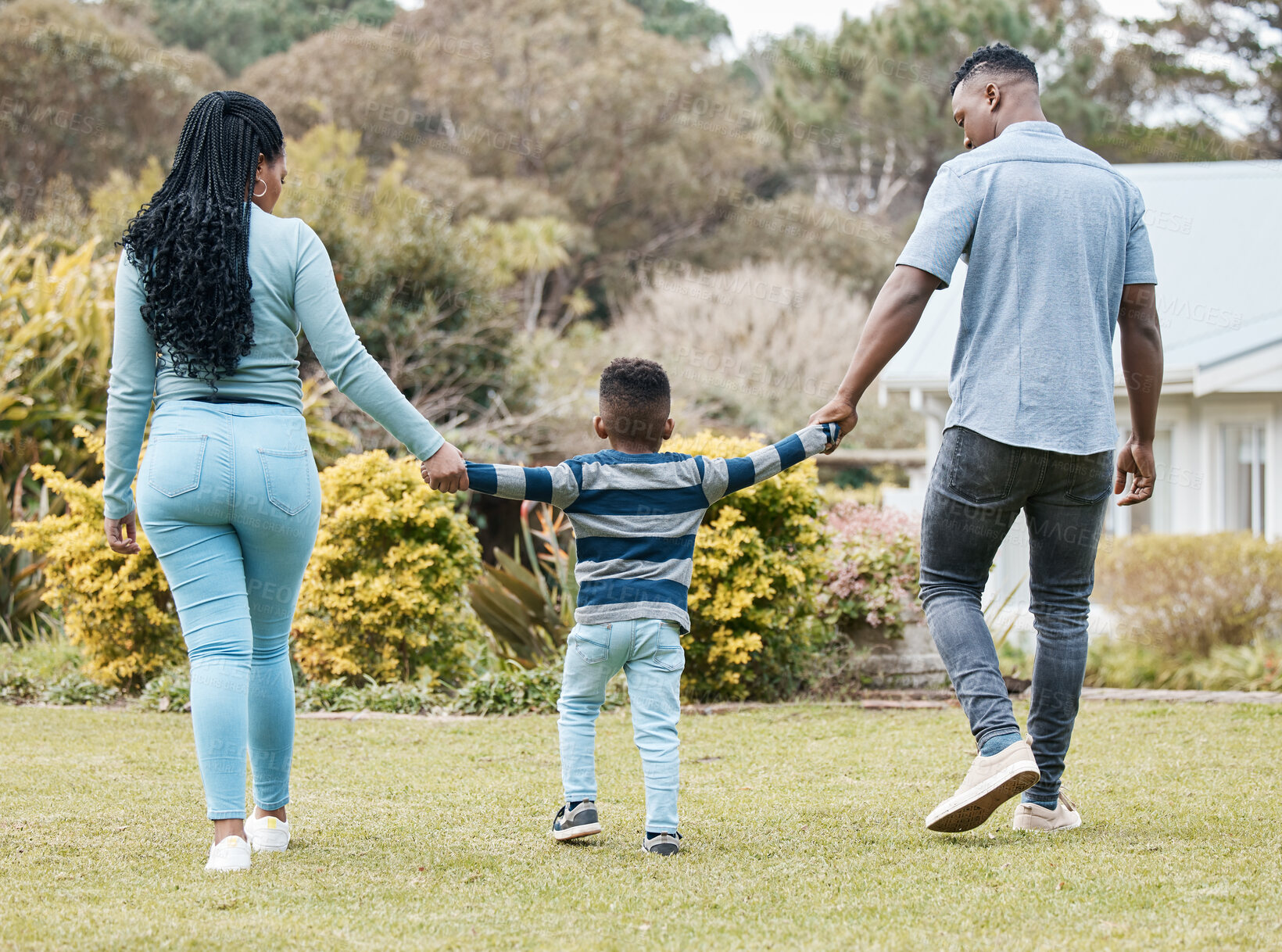 Buy stock photo Full length shot of an unrecognisable couple bonding with their son in the garden