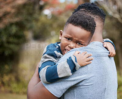 Buy stock photo Shot of an unrecognisable father comforting his son while bonding with him in the garden
