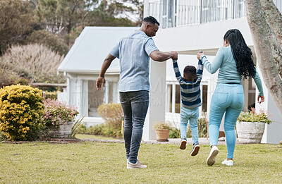 Buy stock photo Mother and father lifting child by their new home in the outdoor garden while playing together. Backyard, bonding and back of African parents holding their boy kid in the backyard of their house.