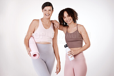 Buy stock photo Cropped portrait of two attractive young female athletes posing in studio against a grey background
