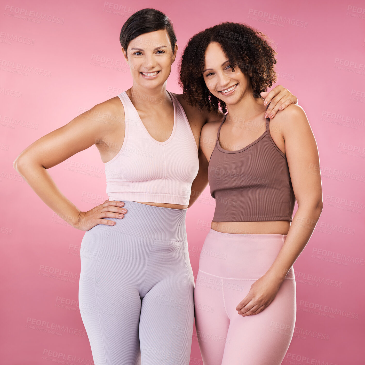 Buy stock photo Cropped portrait of two attractive young female athletes posing in studio against a pink background