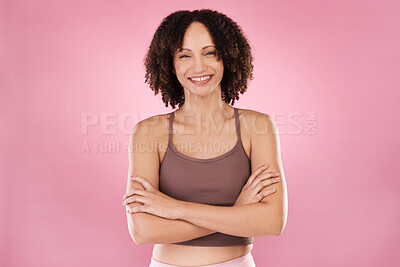 Buy stock photo Cropped portrait of an attractive young female athlete standing with her arms folded in studio against a pink background