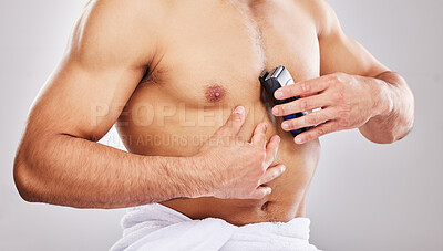 Buy stock photo Studio, grooming and chest of man for shaving, cleaning and self care with electric equipment. Male model, wellness and skincare with trimmer, hair removal or hygiene maintenance by white background