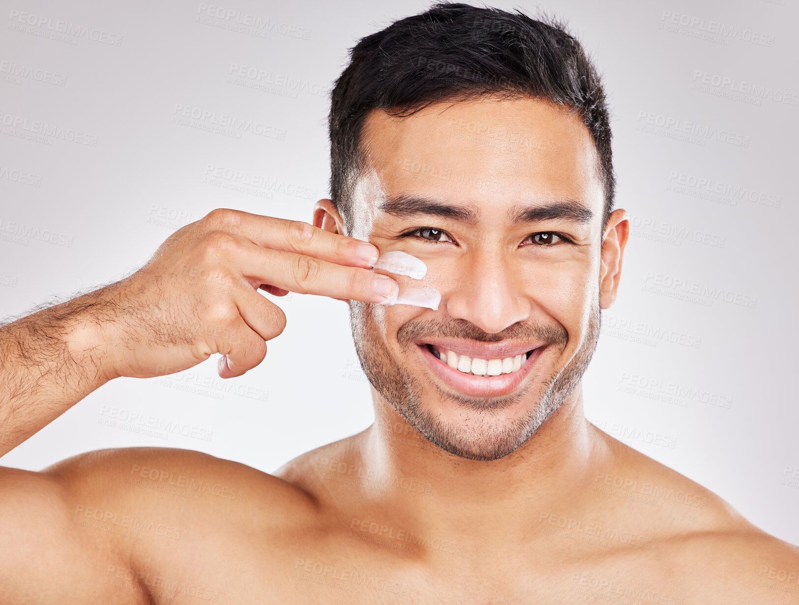 Buy stock photo Face, portrait and asian man with lotion in studio for skin hydration, anti aging or collagen. Moisturizer, male model or skincare with cosmetics for smooth, glow or soft texture by white background