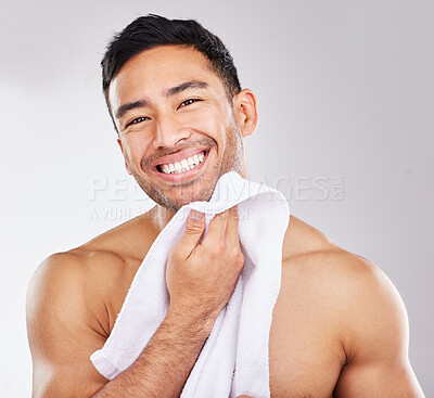 Buy stock photo Man, portrait and towel in studio for skincare or hygiene, self care and daily morning grooming for wellness or dermatology. Person, isolated and white background with cosmetics and happiness.