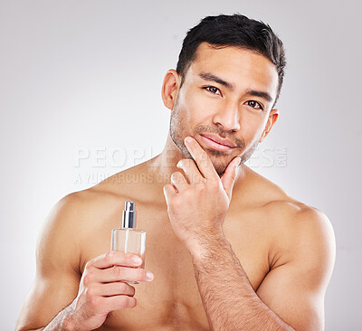 Buy stock photo Portrait, man and perfume in studio with skincare or grooming for self care, scent and natural cosmetics for face. Fresh, isolated and white background with fragrance cologne for aftershave routine.