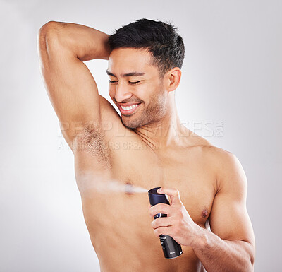 Buy stock photo Happy, man and spray in studio for hygiene or grooming for self care, wellness and natural cosmetics for scent. Person, isolated and white background with fragrance perfume for fresh armpits.